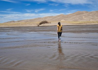 2022-06-04 USA Colorado Great Sand Dunes National Park creek woman walking national park dunes sand water river