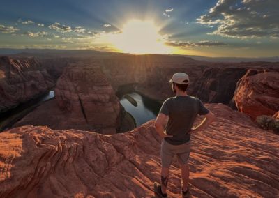 2022-06-16 USA Arizona Page Horseshoe Bend sunset river Colorado river rocks red sky clouds colors red blue green landscape canyon man