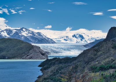 2023-01-11 Chile Patagonia Puerto Natales Torres del Paine National Park Parque Nacional the best the most beautiful hike magnificent trailMulti-day hike W-Trek day day stage 1 Lago Glacier Grey lake Grey mountains snow viewpoint observation point clouds blue sky